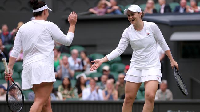 Ash Barty with Casey Dellacqua during the Ladies' Invitation Doubles match against Andrea Petkovic of Germany and Magdalena Rybarikova of Slovakia on Wimbledon’s centre court. Picture: Getty Images