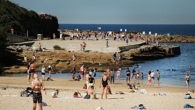 What is more concerning – people that flout social distancing at the beach or those who refuse to download the tracing app? Picture: Richard Dobson / News Corp