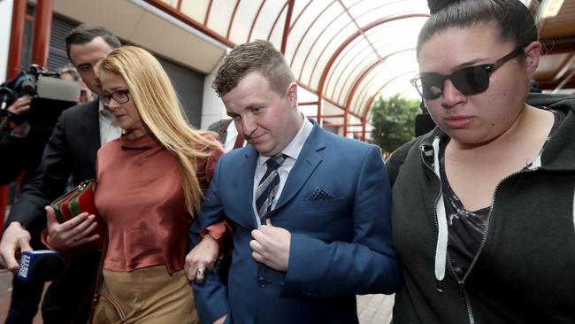 William Russell, centre, leaves the Adelaide District Court in October with supporters after an earlier court appearance. Picture: AAP / Kelly Barnes