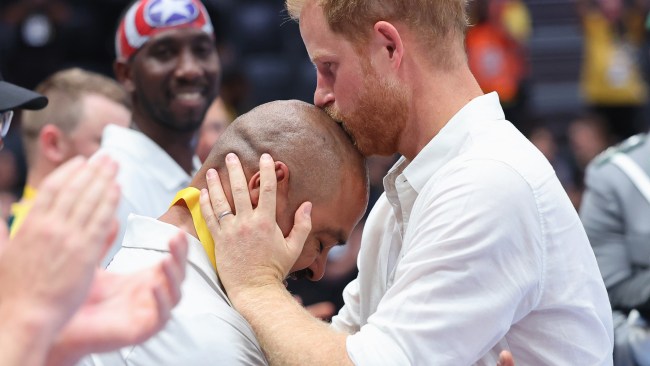 Prince Harry was captured planting a kiss on an Invictus Games athlete’s head during the medal ceremony on Monday night. Picture: Getty Images.