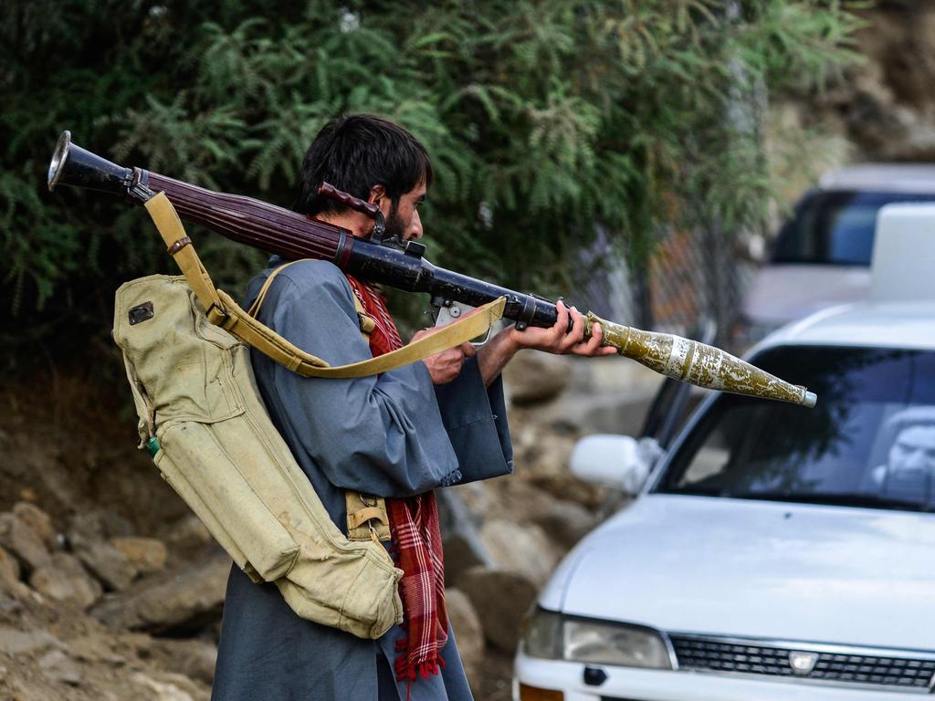 Afghan armed men supporting the Afghan security forces against Taliban carries a weapon as he walks along a road in Panjshir province. Picture: AFP