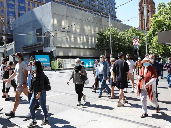 MELBOURNE, AUSTRALIA - NewsWire Photos NOVEMBER 2 , 2020 :The city of Melbourne begins to open up again after a harsh lockdown due to a second wave of coronavirus.Pedestrians cross on the corner of Swanston St. and Collins St. Picture : NCA NewsWire / Ian Currie