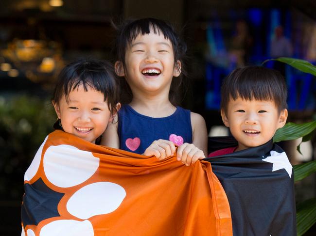 L to R Liz Liu 4 ,  Sophia Shen 6 and Nicolas Shen 3 seeing in Territory Day 2020 at the Darwin Waterfront.Picture GLENN CAMPBELL