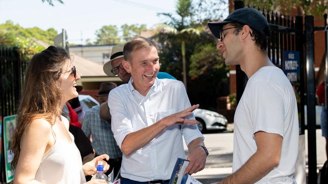 Bruce Notley-Smith on the campaign trail with voters Daniel and Lisa Milech at Randwick Public School. Picture: AAP Image/Monique Harmer