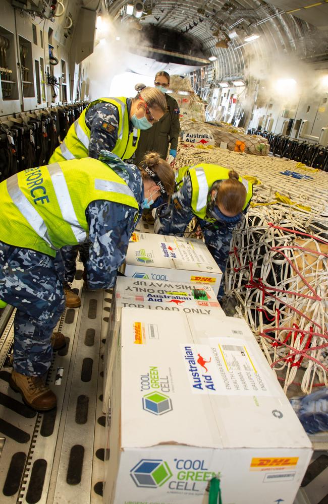 RAAF personnel load Covid-19 vaccines bound for Papua New Guinea onto a C-17A Globemaster III at RAAF Base Amberley. Picture: Sgt Peter Borys.