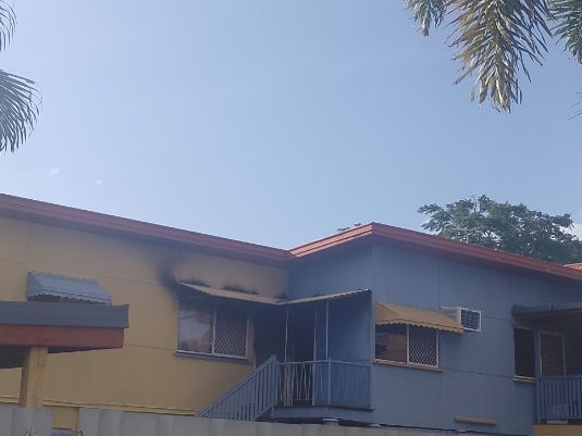 Queensland Fire Service firefighters searching units at the scene of a fire on West Street, The Range this afternoon.