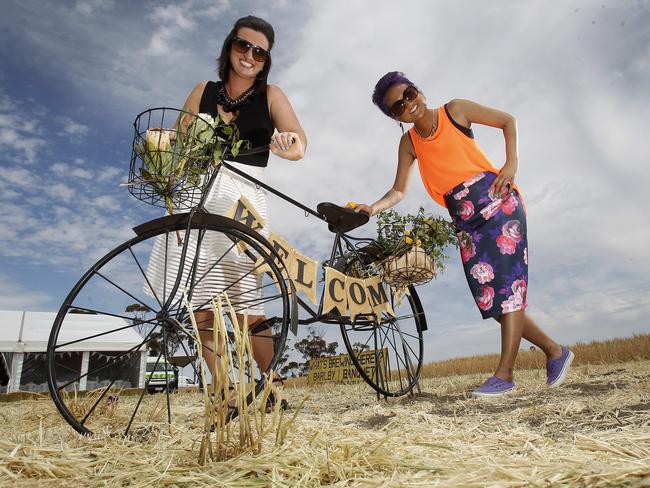 Bec Chamberlain, Merbein and Jules Prins, from Ouyen take a fancy to the welcome bike at the Rupanyup Barley Banquet. Picture: Yuri Kouzmin