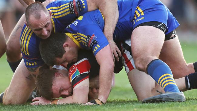 Seb Plaister held by the Toukley defence. Picture: Sue Graham