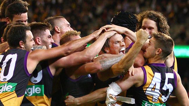 Sam Lloyd is swamped after his matchwinning heroics.