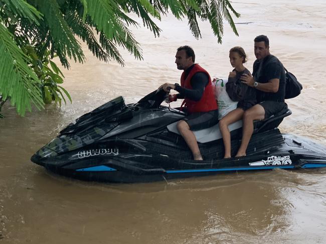 Joel Parkinson helps flood victims to safety on his jet ski.