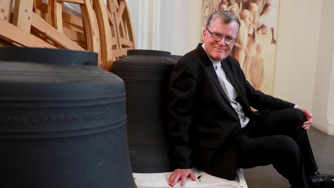 Fr Peter Williams with some of the bells that were donated to St Patrick's Cathedral in Parramatta. Picture: Angelo Velardo