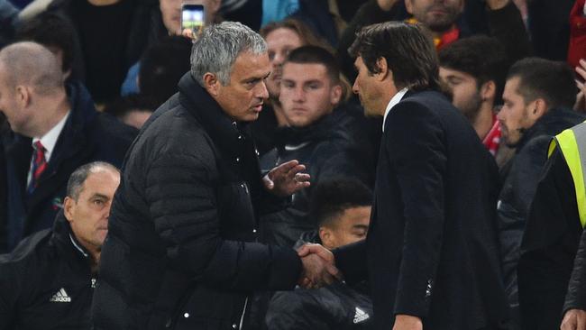 Jose Mourinho (L) shakes hands with Antonio Conte (R).