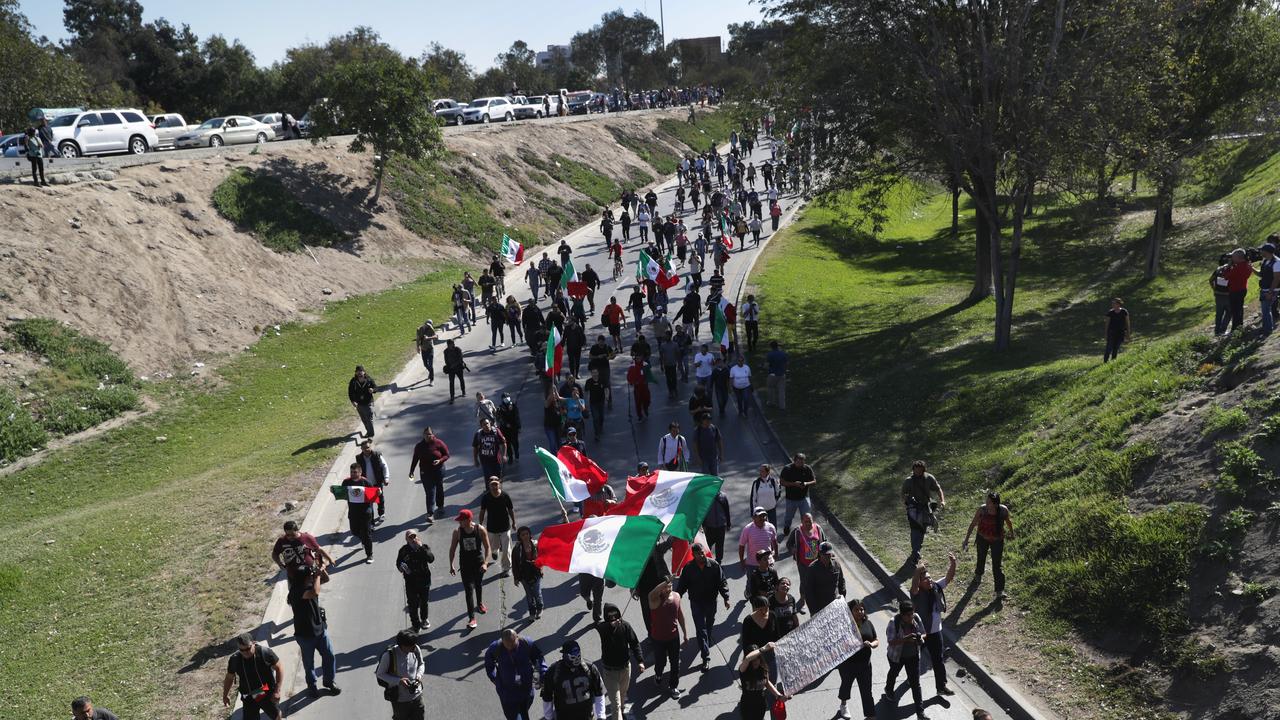 Anti-immigrant protesters march towards an immigrant shelter in November, 2018 in Tijuana, Mexico. Mr Trump has vowed to keep illegal immigrants out of the United States, no matter what. Picture: John Moore/Getty Images