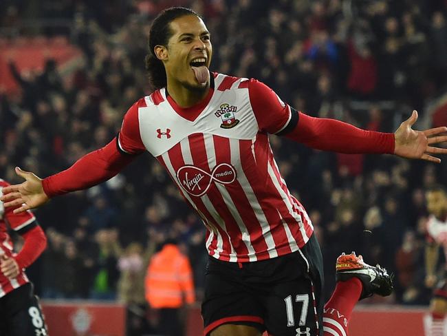 (FILES) This file photo taken on December 28, 2016 shows Southampton's Dutch defender Virgil van Dijk (C) celebrates scoring the opening goal during the English Premier League football match between Southampton and Tottenham Hotspur at St Mary's Stadium in Southampton, southern England on December 28, 2016. Liverpool have signed Southampton's Virgil van Dijk, a statement on the club's website said on December 27, 2017, for a reported £75 million ($100 million, 84 million euros) in a deal that will make him the world's most expensive defender. / AFP PHOTO / Glyn KIRK / RESTRICTED TO EDITORIAL USE. No use with unauthorized audio, video, data, fixture lists, club/league logos or 'live' services. Online in-match use limited to 75 images, no video emulation. No use in betting, games or single club/league/player publications.  /