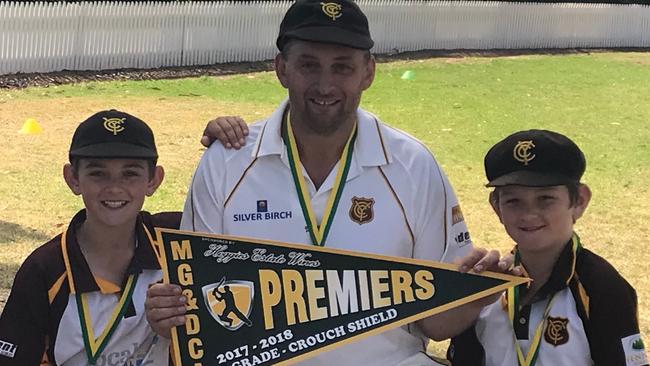 Heath Case celebrating a premiership with sons Hamish and Robby. Picture: Supplied