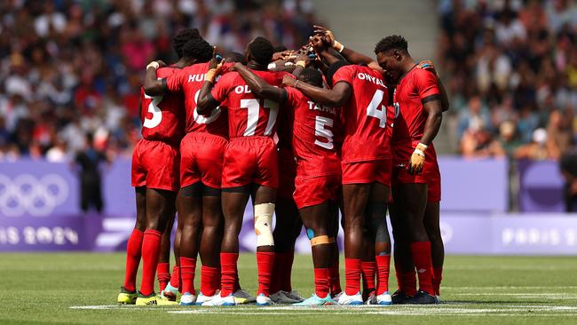 Players of Team Kenya huddle prior to a Men's Rugby Sevens Pool B Group match. Photo by Cameron Spencer/Getty Images.