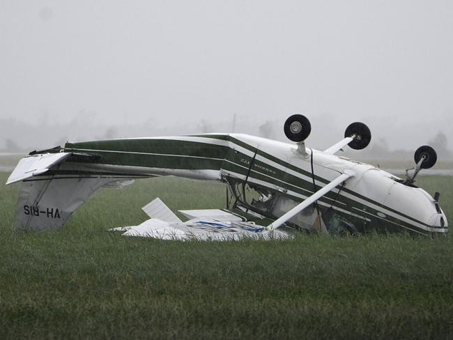 A plane flipped at Bowen Airport during the cyclone. Picture: AAP Image/Sarah Motherwell