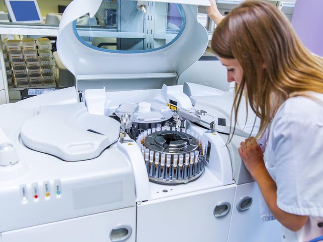 Scene from a blood bank...Young Woman Lab scientist placing test tubes with blood samples in a centrifuge. Picture: iStock