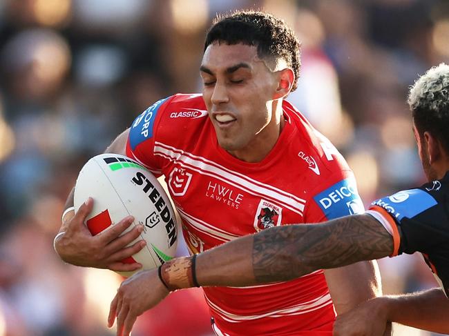 SYDNEY, AUSTRALIA - APRIL 14:  Tyrell Sloan of the Dragons is tackled by Apisai Koroisau of the Tigers during the round six NRL match between Wests Tigers and St George Illawarra Dragons at Campbelltown Stadium, on April 14, 2024, in Sydney, Australia. (Photo by Matt King/Getty Images)