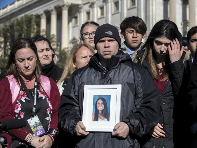 Ilan Alhadeff, joined at left by his wife Lori Alhadeff, holds a photograph of their daughter, Alyssa Alhadeff, 14, who was killed at Marjory Stoneman Douglas High School in Parkland during a rally in Washington, Friday. Picture: AP