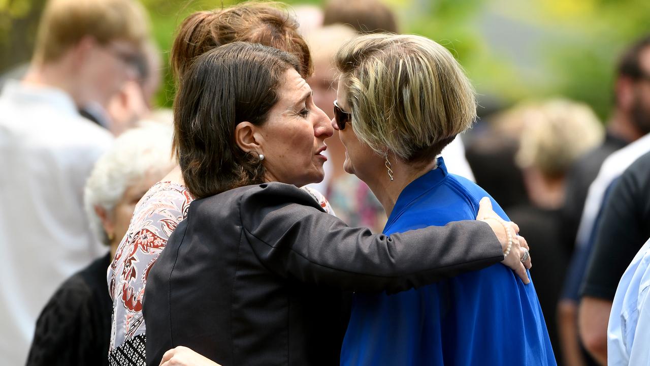 NSW Premier Gladys Berejiklian (left) embraces a mourner during a memorial service for Whakaari/White Island volcano victims Anthony, Elizabeth and Winona Langford at Maris College North Shore Auditorium in Sydney, Monday, December 30, 2019. Picture: Bianca De Marchi/AAP