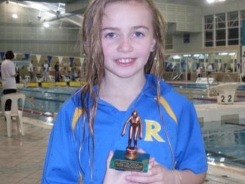 Ariarne Titmus pictured when she was 8-years-old with her trophy after winning a 25m breastroke race. Picture: Supplied