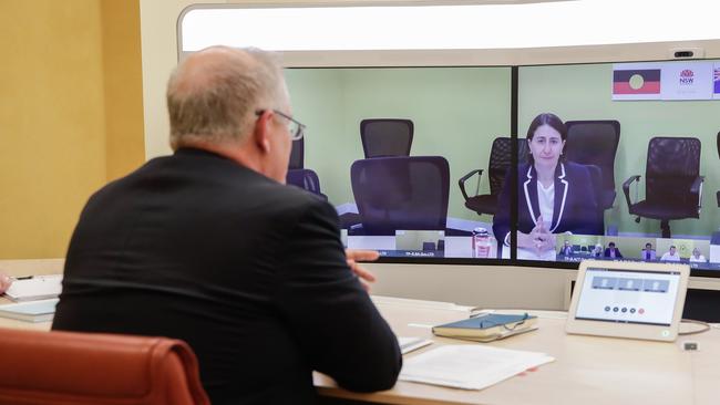 Prime Minister Scott Morrison speaks with NSW Premier Gladys Berejiklian (on screen) during a National Cabinet meeting to discuss COVID-19 from the telepresence room of Parliament House. Picture: Getty Images