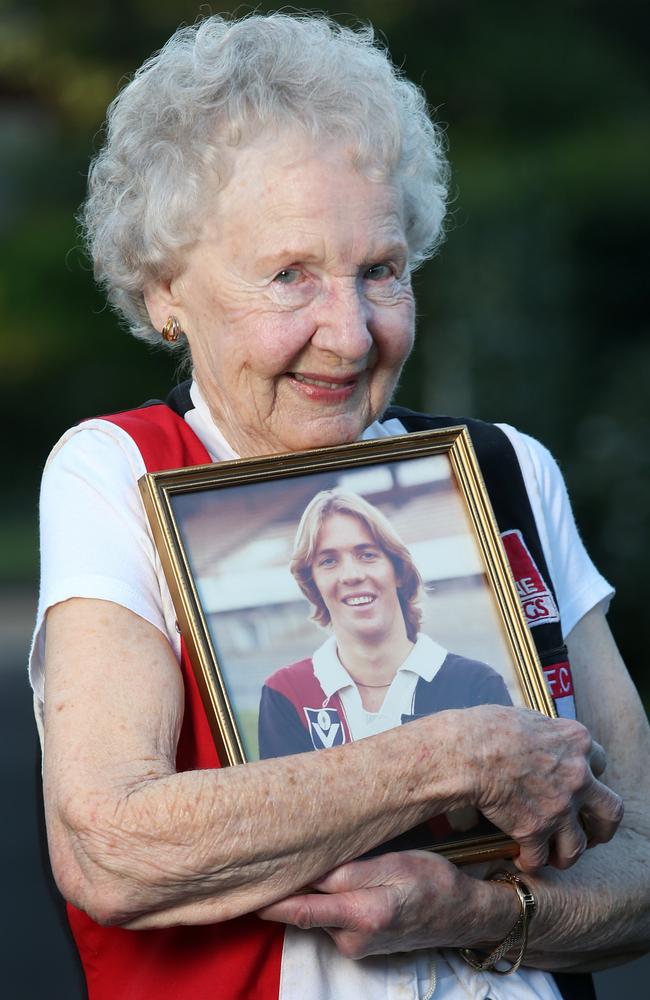 Norma Barker, mother of St Kilda champion Trevor Barker, tries on her son’s jumper after he was admitted to the Australian Football Hall of Fame. Picture: Michael Klein