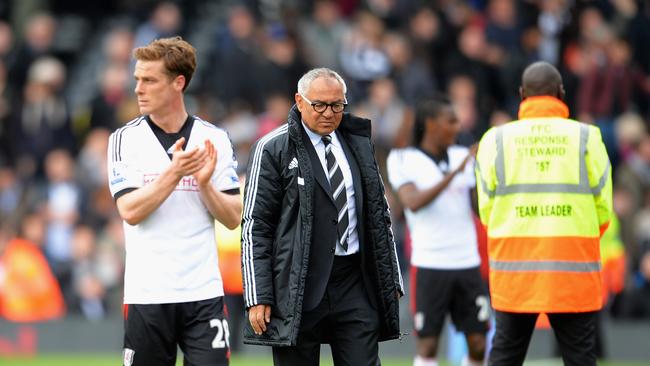 Felix Magath, manager of Fulham looks dejected with Scott Parker.