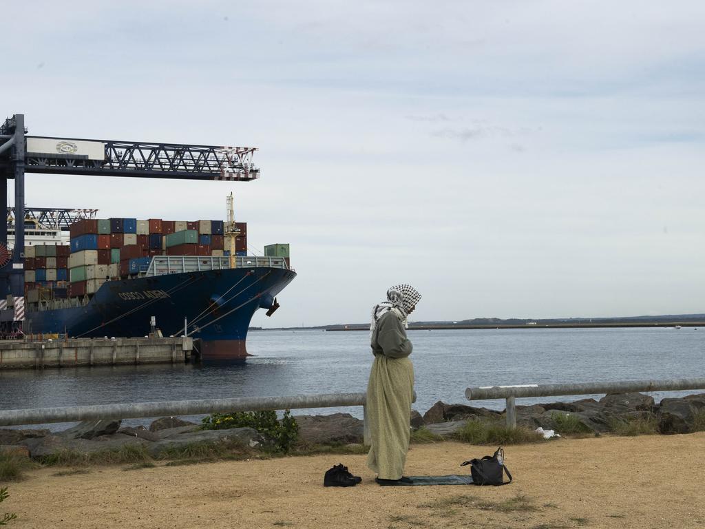 A woman praying during the protest at Port Botany in Sydney on Saturday. Picture: NewsWire / Jeremy Piper