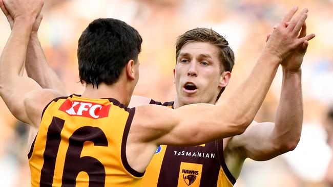 MELBOURNE, AUSTRALIA - AUGUST 18: Dylan Moore of the Hawks is congratulated by Massimo D'Ambrosio after kicking a goal during the round 23 AFL match between Hawthorn Hawks and Richmond Tigers at Melbourne Cricket Ground, on August 18, 2024, in Melbourne, Australia. (Photo by Josh Chadwick/AFL Photos/via Getty Images)