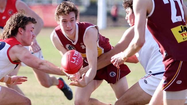 Alexander Alderton fires out a handball for Lower Plenty. Picture: George Sal