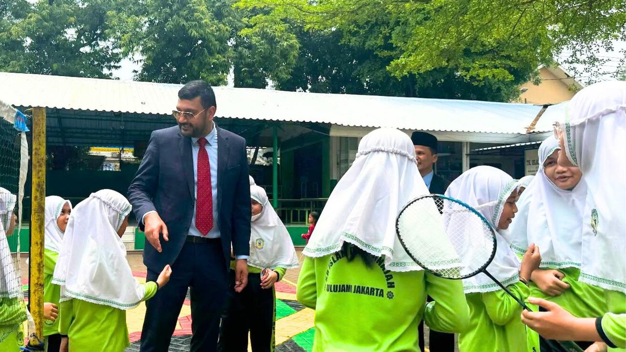 Students play badminton with Ali Kadri at the Indonesian school. Picture: Contributed