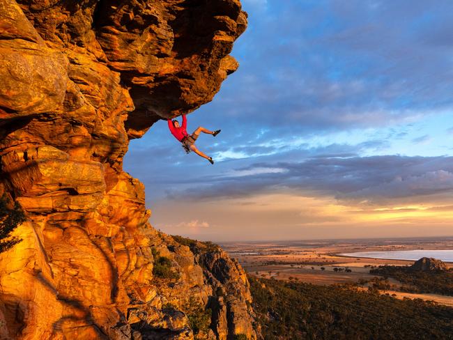 EMBARGO 6AM SATURDAY 6TH APRIL ** WARNING DO NOT USE EMBARGO CONTACT SARAH MATRAY HS PIC DESK IF ANY QUESTIONS** Free climber Tom Perkins swings out on Feeling the Ceiling, a grade 21 climb near the summit of Mount Arapiles at first light. With over two thousand climbs in such a concentrated area of rock this collection of cliffs and gullies is internationally renowned for its quality of climbs and rock, with people traveling from all over to climb here. With climbing bans over large areas already in place due to cultural heritage concerns and more likely to follow, the climbing community are struggling to push back against Parks Victorias broad approach. Picture: Jason Edwards