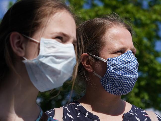 A mother and daughter in Germany wear protective masks as the government looks to ease lockdown measures in an effort to increase economic activity. Picture: Getty Images