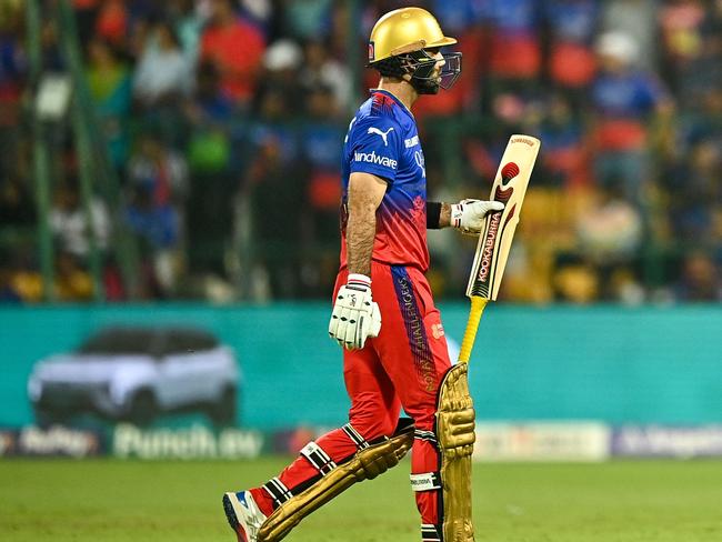 Royal Challengers Bengaluru's Glenn Maxwell walks back to the pavilion after his dismissal during the Indian Premier League (IPL) Twenty20 cricket match between Royal Challengers Bengaluru and Gujarat Titans at the M Chinnaswamy Stadium in Bengaluru on May 4, 2024. (Photo by Idrees MOHAMMED / AFP) / -- IMAGE RESTRICTED TO EDITORIAL USE - STRICTLY NO COMMERCIAL USE --