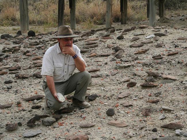 Richard Potts with artefacts in the Olorgesailie Basin in southern Kenya. Stone tools and other items from ancient sites in Kenya give a glimpse at the emergence of some key human behaviours, perhaps including a building of relationships with long-distance neighbours. Picture: Jason Nichols