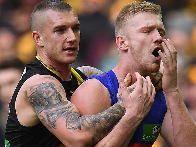 Dustin Martin of the Tigers (left) and Nick Robertson of the Lions clash during the Round 17 AFL match between the Richmond Tigers and the Brisbane Lions at Etihad Stadium in Melbourne, Sunday, July 16, 2017. (AAP Image/Julian Smith) NO ARCHIVING, EDITORIAL USE ONLY
