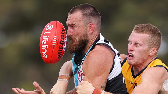 Charlie Dixoncompete for the ball during the 2021 pre-season match against the Crows. Picture Daniel Kalisz/Getty Images)