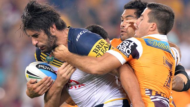 James Tamou of the Cowboys attempts to break free from the Broncos defence.