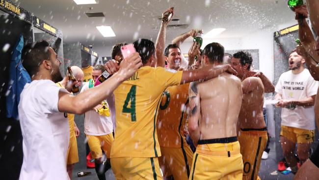Socceroos players celebrate victory in the dressing rooms after the Australia v Honduras World Cup decider at ANZ Stadium, Sydney. Picture: Brett Costello.