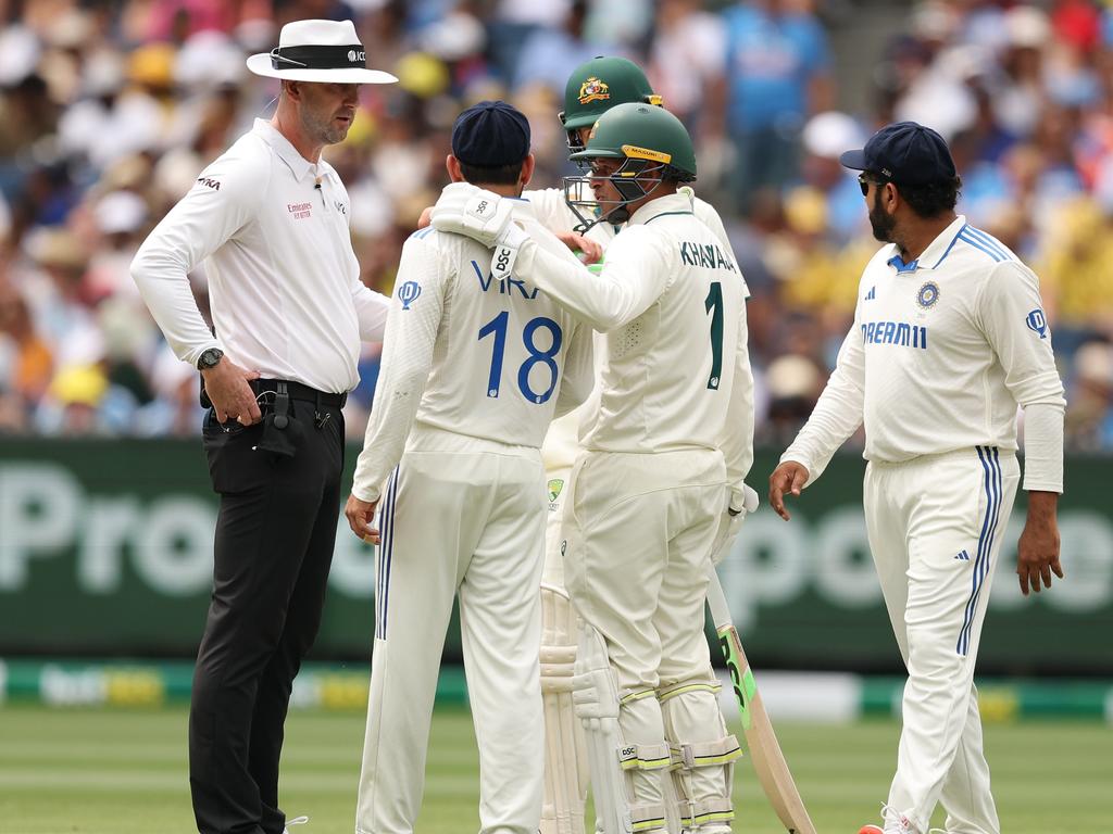 Umpire Michael Gough speaks with Sam Konstas and India’s Virat Kohli. Picture: Getty Images