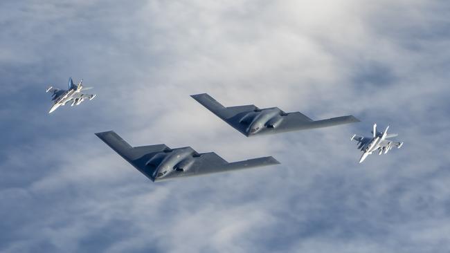 Two Royal Australian Air Force EA-18G Growler jets fly in formation with two United States Air Force B-2 Bomber aircraft. Picture: FSGT Christopher Dickson