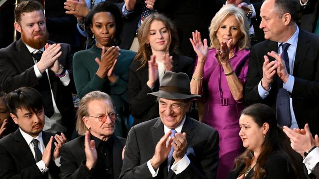 Jill Biden, US second gentleman Doug Emhoff, top right, Irish singer-songwriter Bono, former speaker Nancy Pelosi’s husband Paul, centre, and Brandon Tsay, bottom left, applaud Ukrainian envoy to the US Oksana Markarova. Picture: AFP