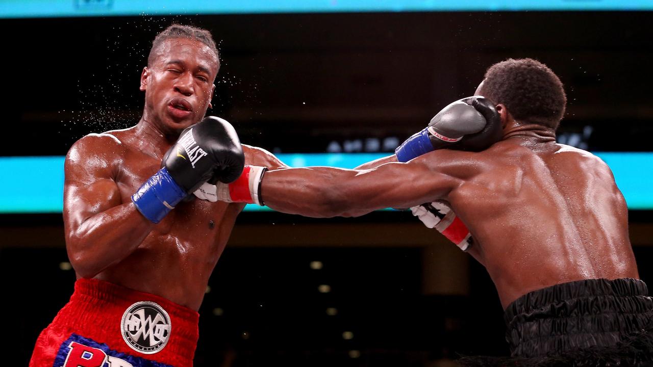 Patrick Day (L) and Charles Conwell exchange punches