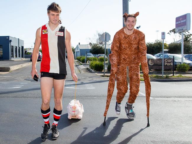 Ryan ‘Plugger’ Gardner and baby giraffe Wylie Buzza. Picture: Mark Stewart