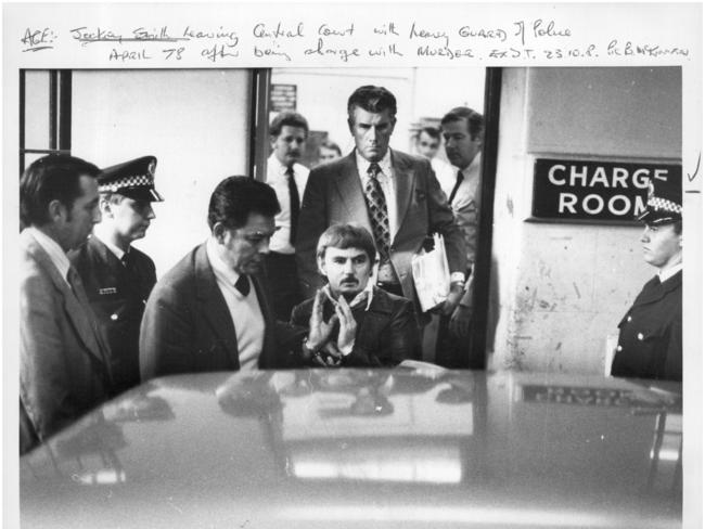 “Jockey” Smith leaves Central Court under heavy police guard in April 1978 after being charged with the murder of bookmaker Lloyd Tidmarsh in 1977 and the shooting of Constable Jerry Ambrose in 1976. Smith was sentenced to life imprisonment but was released on appeal. However, he was sentenced to 15 years for trying to kill detective Bob Godden.