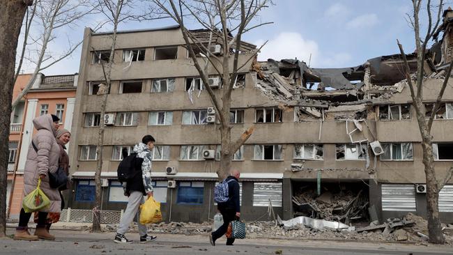 People walk past a damaged building in the Ukrainian city of Mykolaiv. Picture: AFP