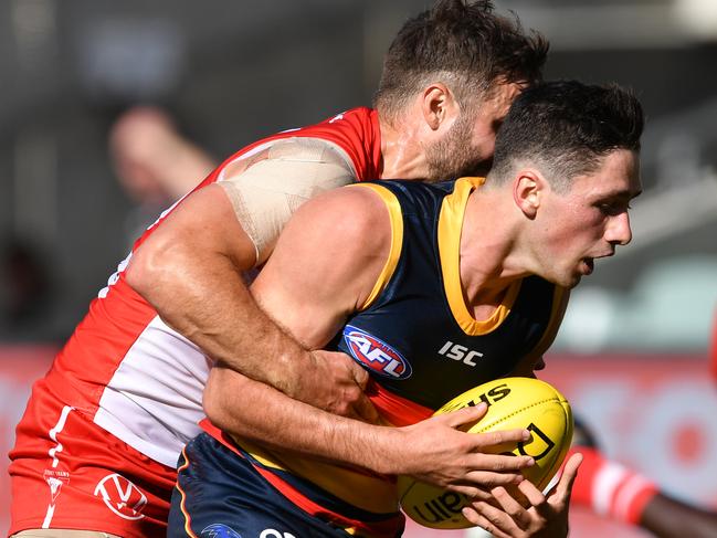 Chayce Jones of the Crows is tackled by Sam Gray of the Swans during the Round 1 AFL match between Adelaide Crows and Sydney Swans at Adelaide Oval in Adelaide, Saturday, March 21, 2020. (AAP Image/David Marauz) NO ARCHIVING, EDITORIAL USE ONLY