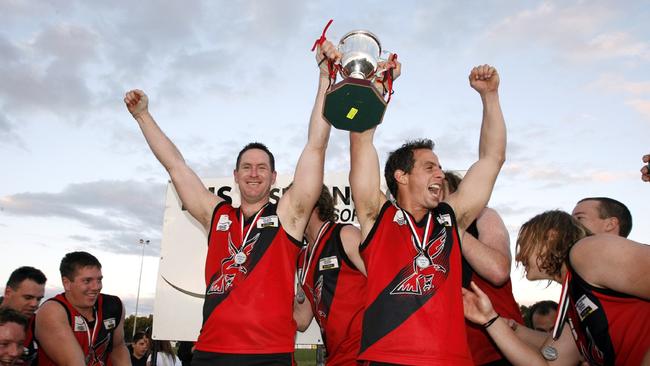 Coach Stuart Wynd and captain Matt Windsor hold the cup aloft. Picture: Paul Loughnan.